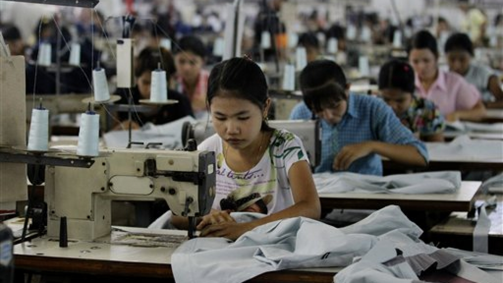 In this April 21, 2012 photo, young workers use sewing machines at a garment factory in Yangon, Myanmar. The European Union confirmed Monday, April 23, 2012, that it was suspending most of its sanctions against Myanmar to reward the country's recent wave of political reform. The suspension of trade sanctions could help revive the nation's industries, restoring some of the 80,000 garment industry jobs lost here over the past 10 years. (AP Photo/Sakchai Lalit)