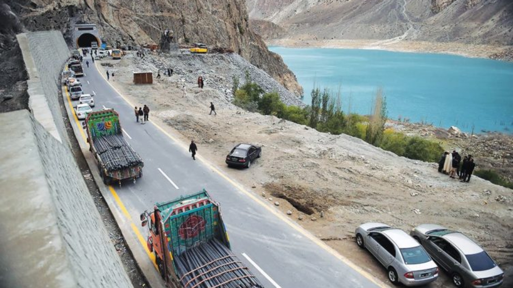 To go with story 'Pakistan-China-economy-transport, FEATURE' by Guillaume LAVALLÉE
In this photograph taken on September 29, 2015, Pakistani commuters wait to travel through a newly built tunnel in northern Pakistan's Gojal Valley.  A glossy highway and hundreds of lorries transporting Chinese workers by the thousands: the new Silk Road is under construction in northern Pakistan, but locals living on the border are yet to be convinced they will receive more from it than dust.    AFP PHOTO / Aamir QURESHI
