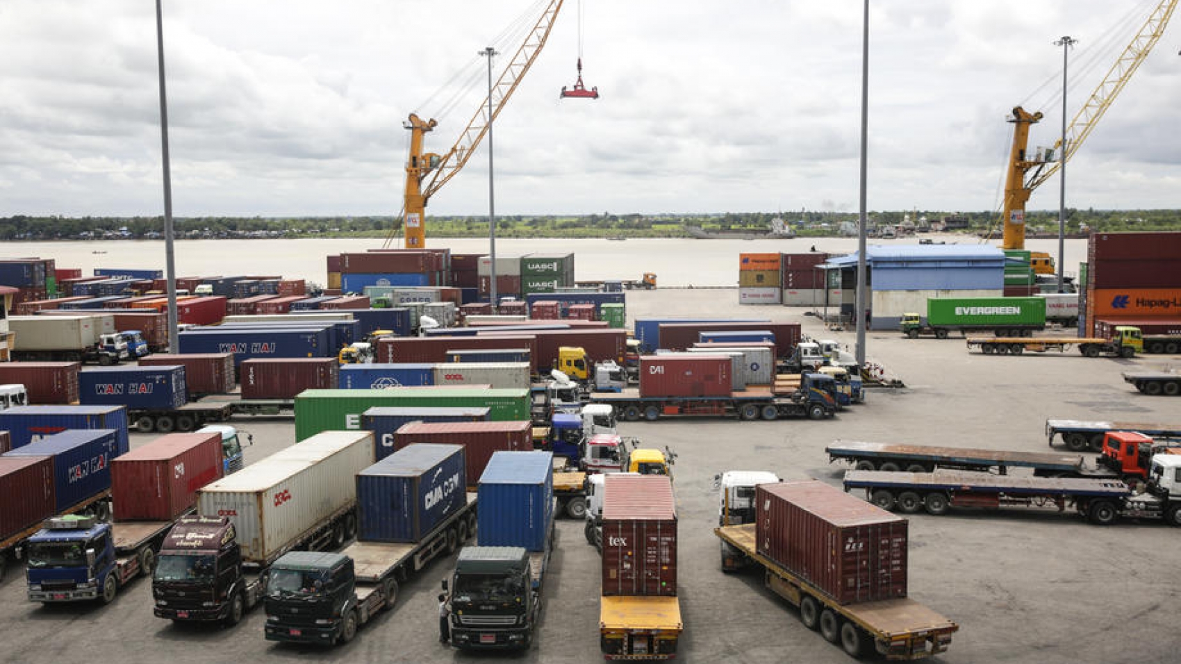 epa07799064 A general view shows trucks loaded containers at Asia World shipping container terminal in Yangon, Myanmar, 28 August 2019. According to figure by Myanmar Ministry of Commerce, Myanmar's total trade with foreign countries reached over 30.593 billion USD as of 16 August 2019 in present fiscal year (from 01 October 2018 to 31 September 2019), of which the export reached 14.69 billion USD while the import was 15.903 billion USD. In 2017-2018 October to September fiscal year, the total trade was 35.895 billion USD and the trade balance had a deficit of 3 billion USD. The most important exports in Myanmar are manufactured products whereas the non-electric machinery and transport equipment are the major products of imports.  EPA-EFE/LYNN BO BO